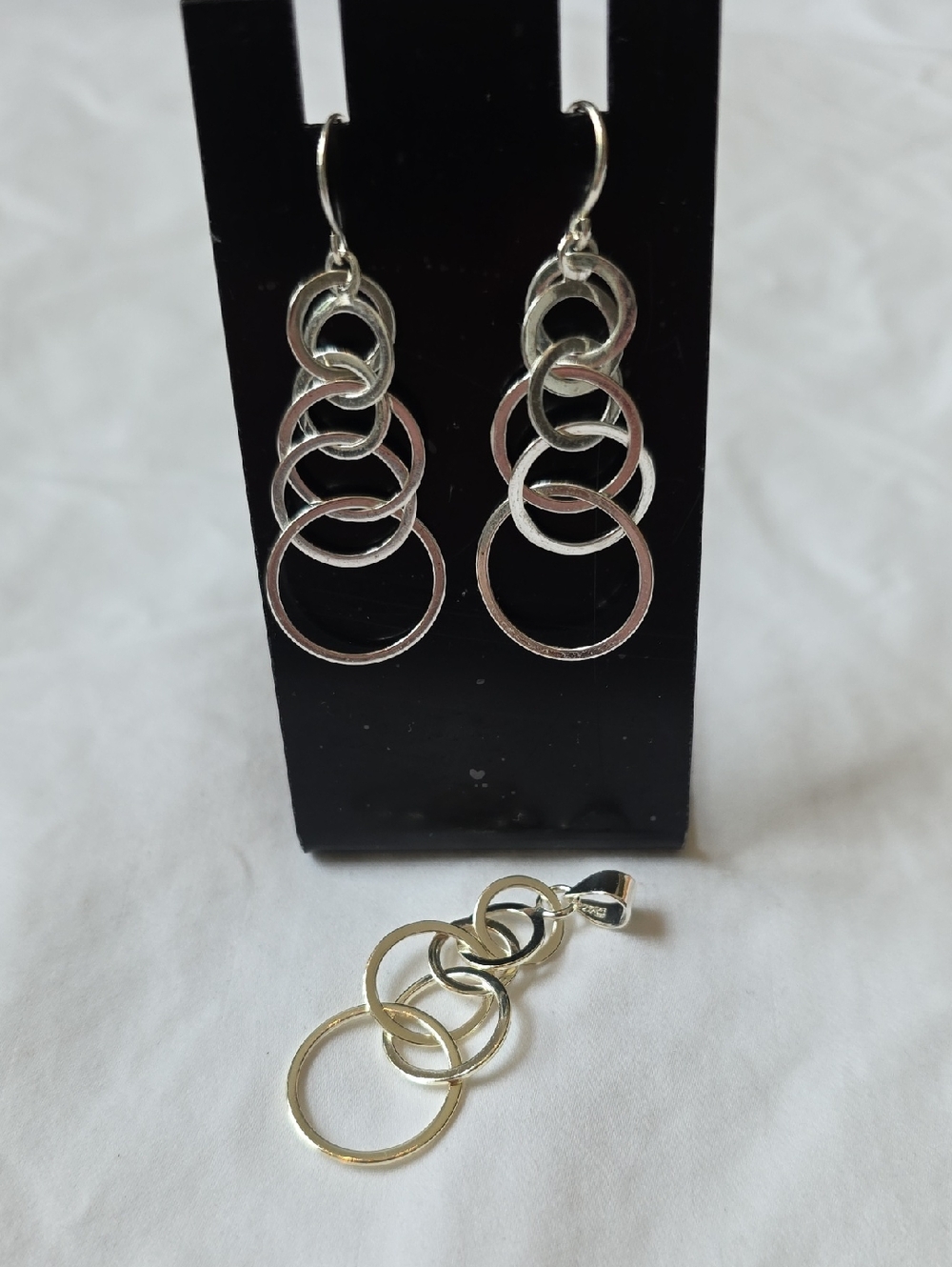 Sterling Silver Layered Interlocking Ring Pendant And Silver Tone Earrings